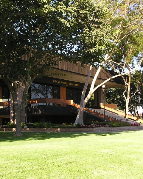The Cypress City Council Chamber behind trees and a lawn
